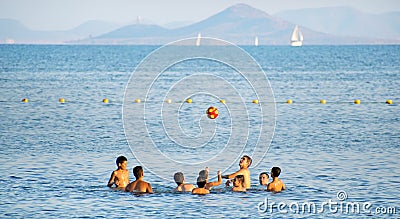 Mar menor, Murcia, Spain, August 5, 2019: Group of happy cute kids play volleyball in water at the beach Editorial Stock Photo