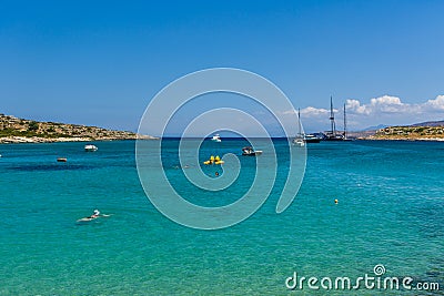 MARATHI, CRETE - 18 JULY 2021: Locals and tourists relaxing on the beach at Marathi on the Chania peninsula of Crete Editorial Stock Photo