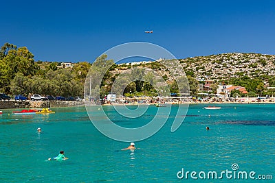 MARATHI, CRETE - 18 JULY 2021: Locals and tourists relaxing on the beach at Marathi on the Chania peninsula of Crete Editorial Stock Photo