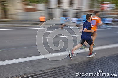 Marathon runner in motion on the street. Healthy lifestyle Editorial Stock Photo