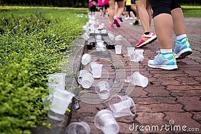 Marathon runners feet and emptry water cups on refreshment point Stock Photo