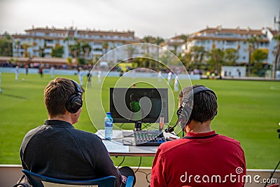 Marbella - January 17, 2020: commentators on football game watching match. stream for television and radio. Editorial Stock Photo