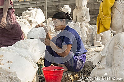 Burmese woman carving a Marble Buddha statue, Mandalay, Burma Editorial Stock Photo