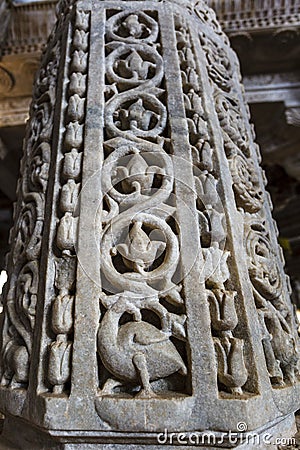 Marble column carved with a beautiful bird and flower pattern in the Jain temple Adinatha temple in Ranakpur, Rajasthan, India Stock Photo