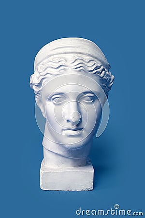 Marble head of young woman, ancient Greek goddess bust isolated on pink background. Gypsum copy of a statue Diana head Stock Photo