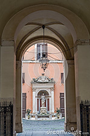 Marble monument statue of a woman in the courtyard in Rome the capital of Italy in potory is arched corridor with antique lantern Stock Photo
