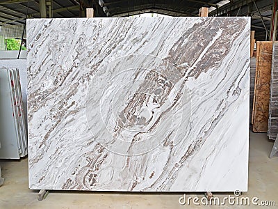Marble slab supported by wooden frame on display in factory Stock Photo