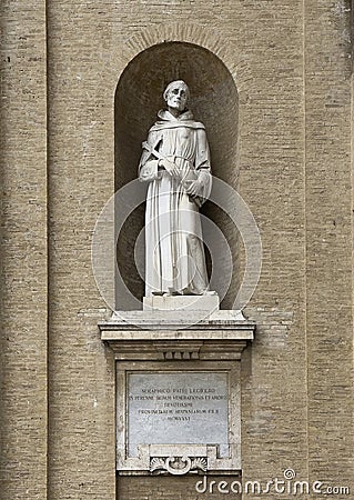 Marble statue of Saint Francis of Assisi on the left front of the Basilica of Saint Mary of the Angels in Assisi, italy. Editorial Stock Photo