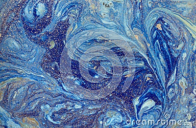 Marbled blue abstract background with golden sequins. Liquid marble ink pattern. Stock Photo