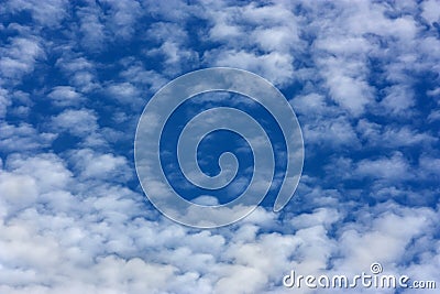 Marbled cloud shape in an intense blue sky. Stock Photo