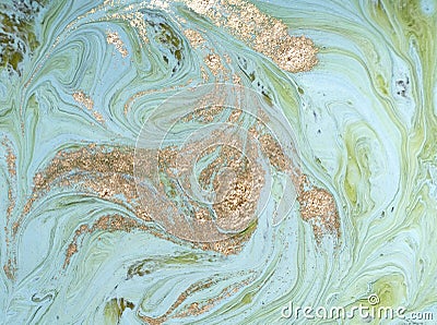 Marbled green abstract background with golden sequins. Liquid marble ink pattern. Stock Photo