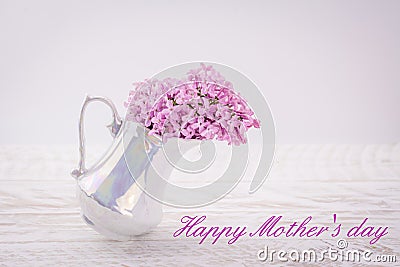 Cup with lilac on wooden background Happy mothers day text Stock Photo