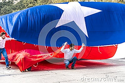 MARCH 3, 2018 - AUSTIN TEXAS - University of Texas students carry Texas flag down Congress Avenue. Mexico, Annual Editorial Stock Photo