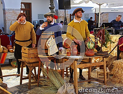 Men in medieval peasant costumes relax at the Spanish festival Editorial Stock Photo