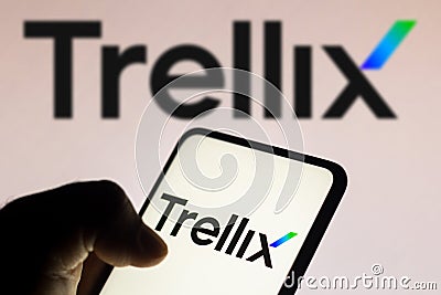 March 10, 2022, Brazil. In this photo illustration the Trellix logo seen displayed on a smartphone and on the background Cartoon Illustration