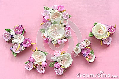 March 8 inscription lined with multicolored pastel flowers in Russian letters on a pink background. Stock Photo