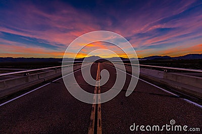 MARCH 12, 2017, LAS VEGAS, NV - Highway overpass above Interstate 15, south of Las Vegas, Nevada at sunset with yellowline Stock Photo