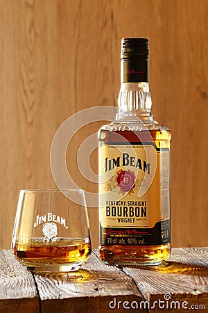 March 28, 2019, Minsk, Belarus - Bottle of kentucky bourbon whiskey with glass on wooden background Editorial Stock Photo