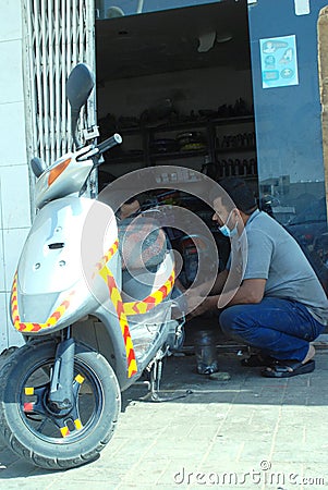 2 march 2021,riyadh Saudi Arabia,An Indian motor bike mechanic at work with safety mask Editorial Stock Photo