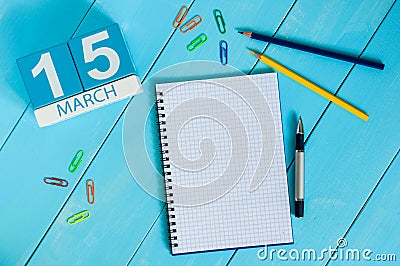 March 15th. Day 5 of month, calendar on blue wooden table background with notepad. Spring time, empty space for text Stock Photo