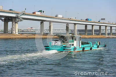 2019 March 28. Tokyo Japan. Japanese trash keeping boat flowing along river surface for cleaning every day. Editorial Stock Photo