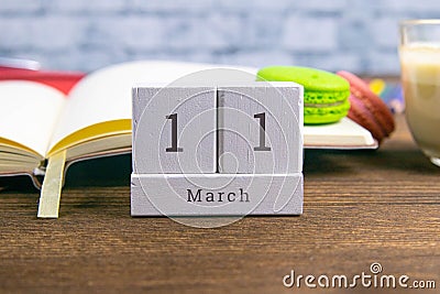 March 11 on the wooden calendar.The eleventh day of the spring month, a calendar for the workplace. Spring Stock Photo