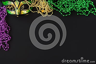 Mardi gras background on black with mask, beads and copy space Stock Photo