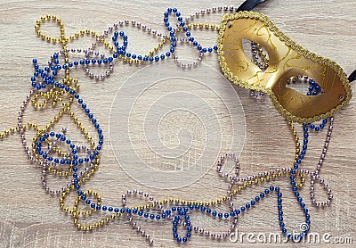 Mardi Gras background with golden mask, beads and copy space. Stock Photo