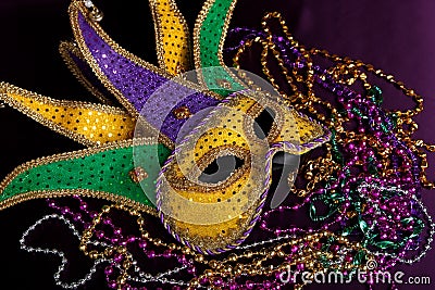 Mardi gras mask and beads on a purple background Stock Photo