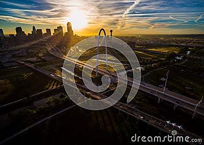 Margaret Hunt Hill Bridge Sunrise Dallas Texas Skyline Downtown Cityscape Sunrise sun rays over Urban Prawl massive City Editorial Stock Photo