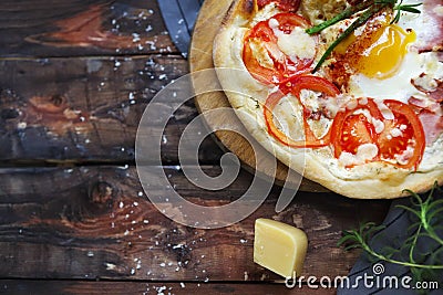 Margarita pizza with basil leaves and egg on wooden table, top v Stock Photo