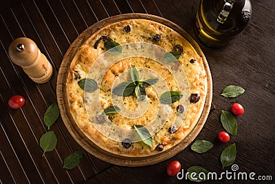 marguerita pizza with top view, decorated with basil, cherry tomatoes and black olives. Stock Photo