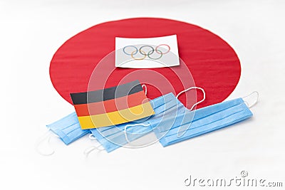 Mari El, Russia - June 16, 2021: The german flag with masks. The Japanese flag background. Tourist trip Editorial Stock Photo