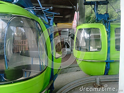 Climbing a mountain in a green cable car cabin in the mountains on a sunny summer day. Czech Republic. Europe. Editorial Stock Photo