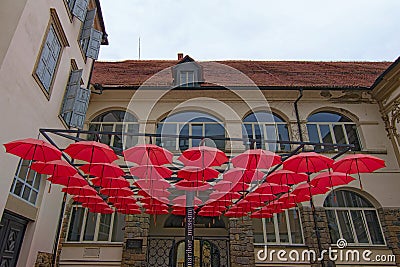 Stunning landscape view of roof of red umbrellas in front of the main entrance to the Regional Museum of Maribor Editorial Stock Photo