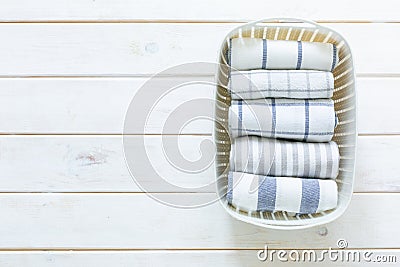 Marie Kondo tidying concept - folded kitchen linens in white basket Stock Photo