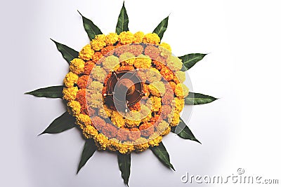 Hindu Festival decoration Flower rangoli using marigold and mango leaf Stock Photo