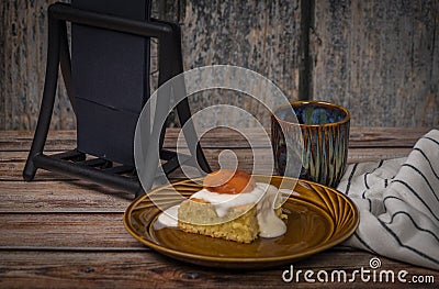 Marijuana vanilla apricot cake on brown dish and wooden table with cup Stock Photo