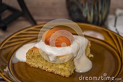 Marijuana vanilla apricot cake on brown dish and wooden table with cup Stock Photo