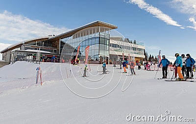 MARILLEVA. JAN 25, 2023. Rifugio Alpe Daolasa 2045m. Skiing area in the Dolomites Alps. A group of skiers in front of Rifugio Alpe Editorial Stock Photo