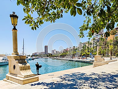 Marina in Alicante, lamp post, sea, and yachts. Mediterranean tranquil sea, beautiful yachts and green trees Editorial Stock Photo