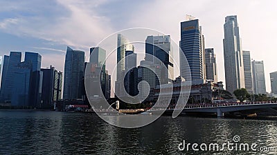 Marina Bay, Singapore May, 2018: View of business district and The Merlion Park. Moving clouds with Singapore city Editorial Stock Photo