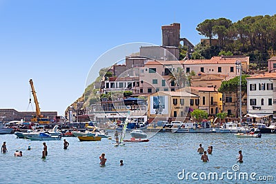 Small town on the coast of the Island of Elba in Italy. Numerous people on vacation. Editorial Stock Photo