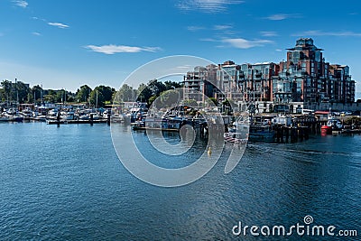 A marina at the entrance to Victoria harbour, Vancouver Island, Canada, sparkling blue waters and bright blue sky. Stock Photo