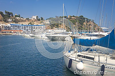 Marina with yachts in Blanes, Costa Brava, Spain. Sail boats in sea port. Sailboat harbor, many beautiful moored sail yachts Stock Photo
