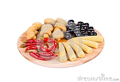 Marinaded vegetables on wooden platter. Stock Photo