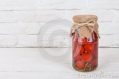 Marinated cherry tomatoes in a jar. Stocks of food. Stock Photo