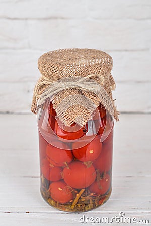 Marinated cherry tomatoes in a jar. Stock Photo