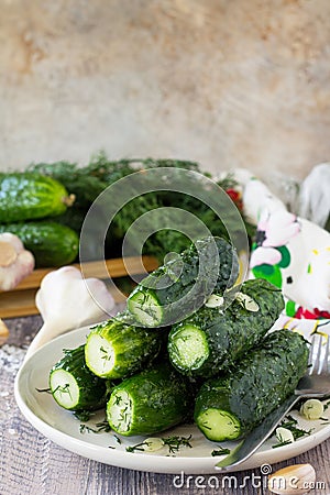 Marinated cucumbers gherkins. Lightly salted cucumber on the kitchen wooden table. Stock Photo
