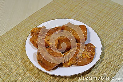 Marinated meat for barbecue on a white plate on the table. Stock Photo